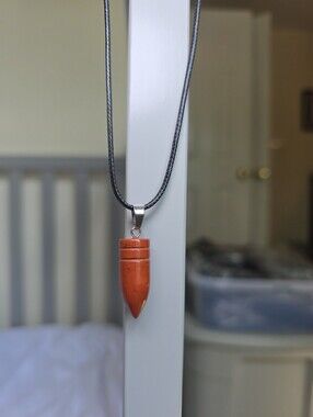 Orange Rust Stone Crystal Bullet Pendant On Black Cord Necklace